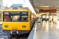 Yellow public transport train bound for Cais do SodrÃÂ© stopped at Cais do SodrÃÂ© train station in Lisbon.