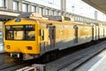 Yellow public transport train bound for Cascais stopped at Cais do SodrÃÂ© train station in Lisbon.