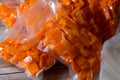 Yellow pumpkin cut into slices and cubes and vacuum packed Royalty Free Stock Photo
