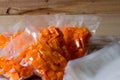 Yellow pumpkin cut into slices and cubes and vacuum packed Royalty Free Stock Photo