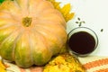 Yellow pumpkin, seeds, bread and oil in the bowl. Harvest on the table and fallen leaves. Autumn products