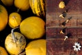 Yellow pumpkins in the ground and dried assorted mushrooms on a red shabby aged wooden background. The image is in two Royalty Free Stock Photo