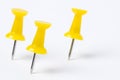 Yellow Pushpins on White Paper