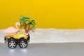 yellow quad arrives at the beach with pink flamingos, creative tropical design, driving to the beach, finally at sea