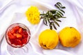 Yellow quince fruit and confiture in glass cup