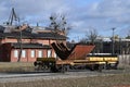 Yellow railway wagon with a part of ship hull old shipyard buildingswith cranes in Gdansk Royalty Free Stock Photo