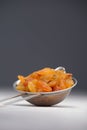 Yellow raisins on an aluminum sieve