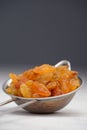 Yellow raisins on an aluminum sieve