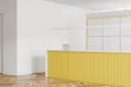 Yellow reception interior desk and cupboard storage. Mockup wall