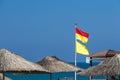 Yellow-red and yellow beach warning flags on the hotel plage. International classification, lifeguard protected area. Be careful Royalty Free Stock Photo