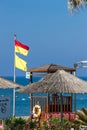 Yellow-red and yellow beach warning flags on the hotel plage. Lifeguard protected area. Be careful when you are in the water. Royalty Free Stock Photo