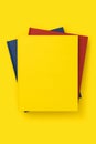 Yellow, red and blue book stack on yellow background, mockup Royalty Free Stock Photo