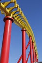 yellow red and blue colours at the roller coaster in bright sunshine