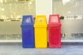 Yellow, red and blue recycling bin on the floor