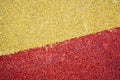 Yellow and red bright soft soft rubber flooring safe for sports and workout or on the playground from the many small round Royalty Free Stock Photo