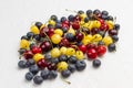 Yellow and red cherry, blueberry on white Royalty Free Stock Photo