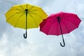 Yellow and red color umbrellas on sky background