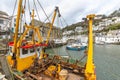 Yellow and Red Fishing Boat Moored in the Historic Polperro Harbour, Cornwall Royalty Free Stock Photo