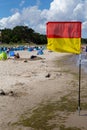 the yellow-red flag for the area on the Baltic Sea on the island of Usedom monitored by lifeguards Royalty Free Stock Photo