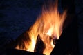 yellow-red flame of burning firewood on a brazier on a cold summer night Royalty Free Stock Photo