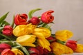 Yellow red flowers tulips fresh bouquet with green leaves and stem with wet drops of fresh water dew close up Royalty Free Stock Photo