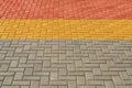 Yellow, red and grey paving tiles for background or texture Royalty Free Stock Photo