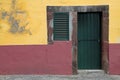 A yellow and red house with green door and window Royalty Free Stock Photo