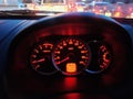 Yellow Red Illuminated Speedometer Console Against Blurred Traffic Background Royalty Free Stock Photo