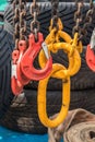 Yellow and red large industrial hooks on chains for lifting Royalty Free Stock Photo