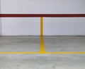 Yellow and red lines on a wall and a concrete floor delimiting s Royalty Free Stock Photo