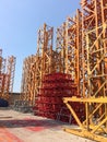 yellow and red metallic element of a crane stored in a dedicated place outoors