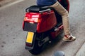 Yellow red motorcycle license plate on the street in Barcelona city