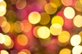 Yellow, red and orange glitter -- abstract festive elegant background with blurred bokeh lights. Royalty Free Stock Photo