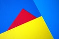 Yellow and red paper on blue background. Royalty Free Stock Photo