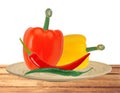 Yellow and red paprika pepper and hot chilli peppers on plate Royalty Free Stock Photo