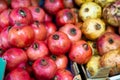 Yellow and red pomegranate fruits are stacked in large and capacious cardboard boxes