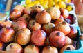 Yellow and red pomegranate fruits are stacked in large and capacious cardboard boxes