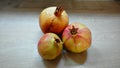 Yellow-red pomegranats on a wooden table Royalty Free Stock Photo
