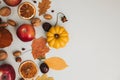 Yellow and red pumpkins on a light background with red apples, dry leaves, chestnuts. Autumn composition, fall Royalty Free Stock Photo