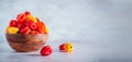 Yellow and red scotch bonnet chili peppers in wooden bowl over grey background. Copy space. Royalty Free Stock Photo