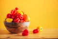 Yellow and red scotch bonnet chili peppers in wooden bowl over orange background. Copy space. Royalty Free Stock Photo