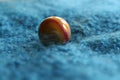 Marble colourful yellow and red close up viewed from eye level blue fabric background landscape format Royalty Free Stock Photo