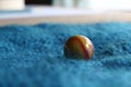 Marble colourful yellow and red close up viewed from eye level blue fabric background landscape format Royalty Free Stock Photo