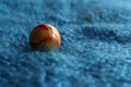 Marble colourful yellow and red close up viewed from eye level blue fabric background landscape format Royalty Free Stock Photo