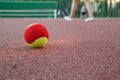 Yellow-red tennis ball on the tennis court in the evening Royalty Free Stock Photo