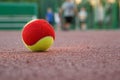 Yellow-red tennis ball on the tennis court in the evening Royalty Free Stock Photo