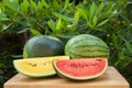 Yellow and red watermelon slice on a wooden table on garden Royalty Free Stock Photo