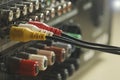 Yellow, red and white audio cables and connectors on music amplifier back panel