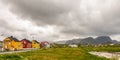 Yellow, red and white norwegian houses along the road in Andenes village, Andoy Municipality, Vesteralen district, Nordland county