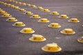 Yellow reflective road studs on a city street, used as a traffic calming measure.